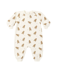 An off-white baby long-sleeve footless one-piece romper with an all-over print of small brown gingerbread men and tiny brown stars, shown on a plain white background.