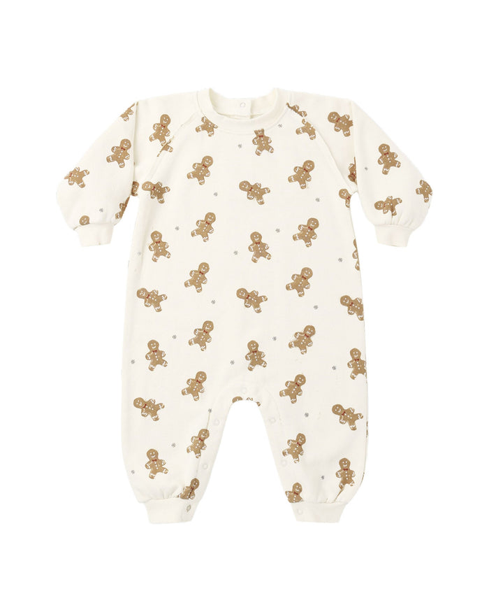 An off-white baby long-sleeve footless one-piece romper with an all-over print of small brown gingerbread men and tiny brown stars, shown on a plain white background.
