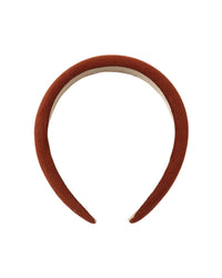 A single headband in a warm rust or terracotta color, photographed against a solid white background.