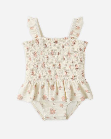 Floral-patterned baby romper on a white background