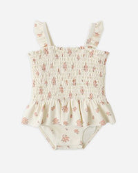 Floral-patterned baby romper on a white background
