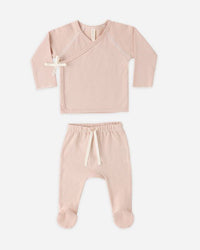 Pink baby outfit with top and pants on a white background