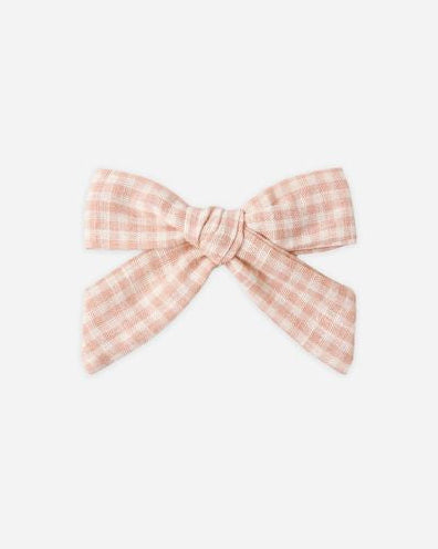 Pink checkered bow on a white background
