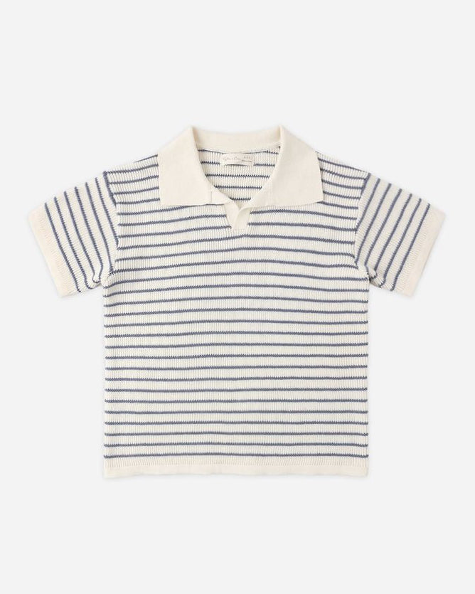 Striped polo shirt with white collar on a light beige background