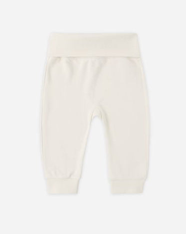 White baby pants on a light beige background