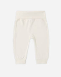 White baby pants on a light beige background