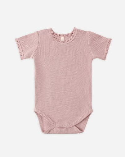 Pink baby bodysuit with ruffled collar on a white background