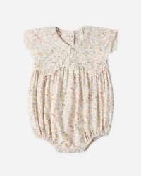 Baby romper with floral pattern on a white background