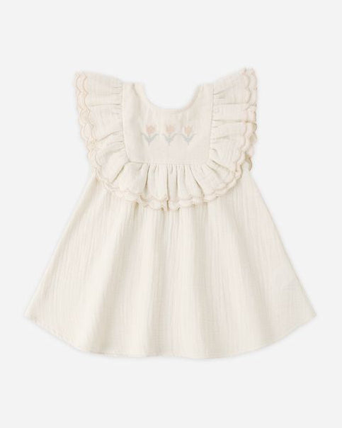 White dress with ruffled details on a white background