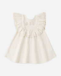 White dress with ruffled details on a white background