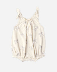 White baby romper with floral patterns on a white background