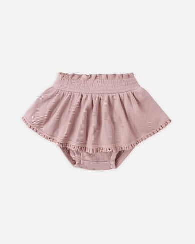 Pink baby bloomers on a white background
