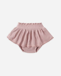 Pink baby bloomers on a white background