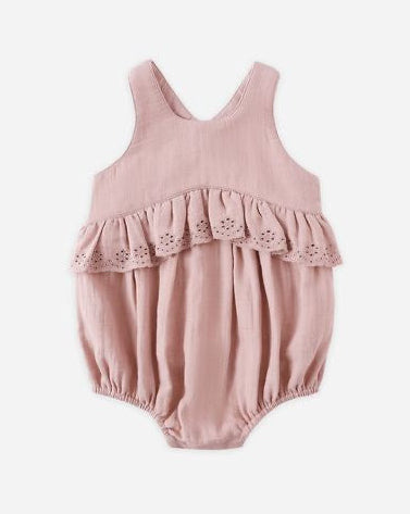 Pink baby romper with lace details on a white background
