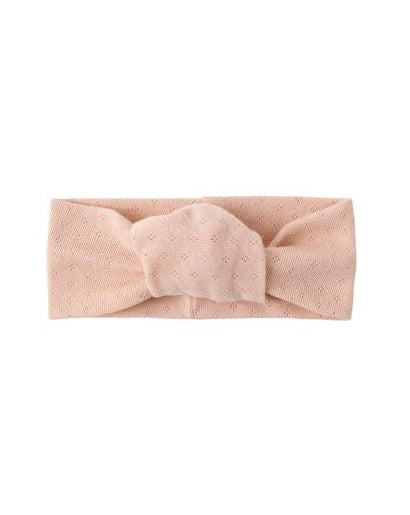 Blush pink headband with a bow on a white background