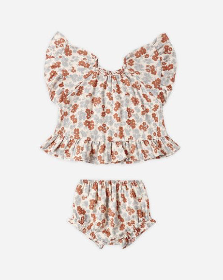 Floral baby outfit with top and bloomers on a white background