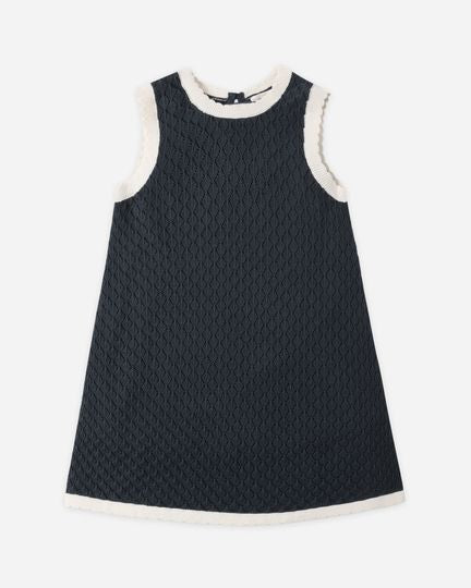 Navy dress with white trim on a white background