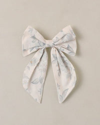 Decorative bow with floral pattern on a beige background