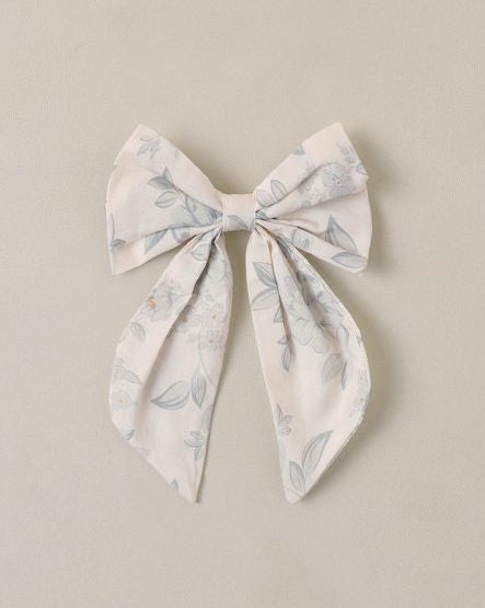 Decorative bow with floral pattern on a beige background