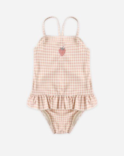 Pink gingham baby romper with ruffle details on a white background