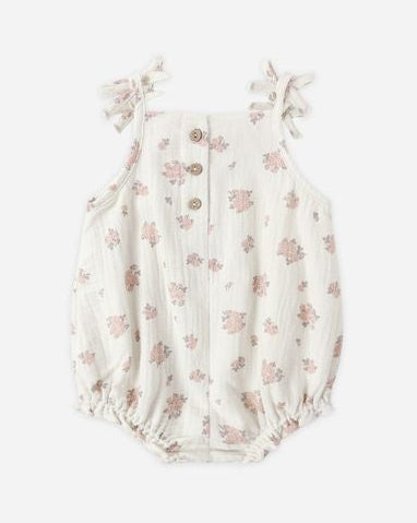 Floral-patterned baby romper on a white background