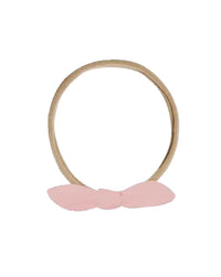 Two hair ties, one beige and one brown, on a white background.