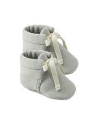 Pair of gray baby booties with white ribbons on a white background
