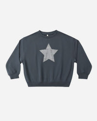 Navy blue sweatshirt with a white star pattern on a light gray background