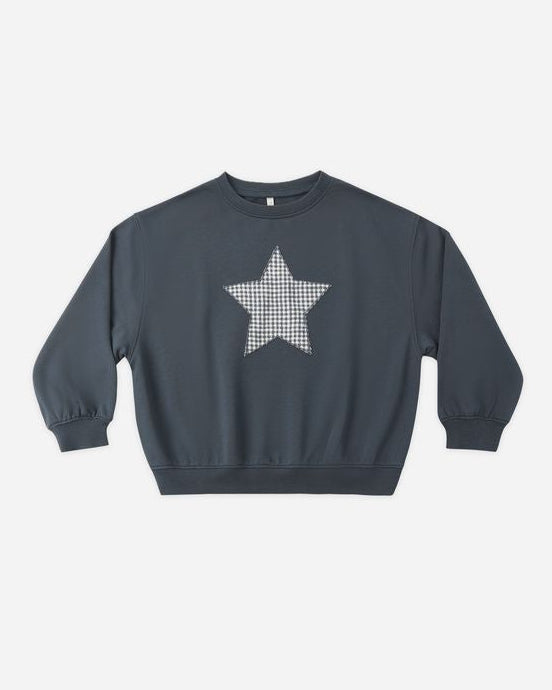 Navy blue sweatshirt with a white star pattern on a light gray background