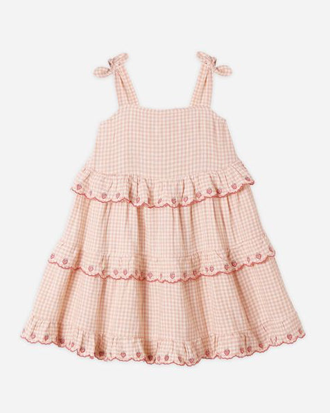 Pink checkered dress with ruffled layers on a white background