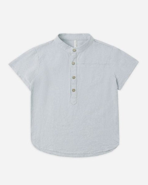 Light blue short-sleeve shirt with buttons on a white background