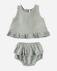 Gray baby outfit with top and bloomers on a white background