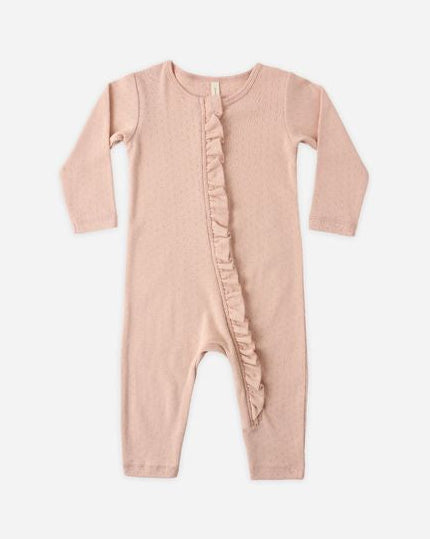 Pink baby onesie with ruffle details on a white background