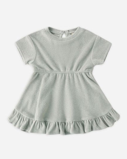 Light gray dress with ruffled hem on a white background