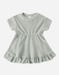 Light gray dress with ruffled hem on a white background