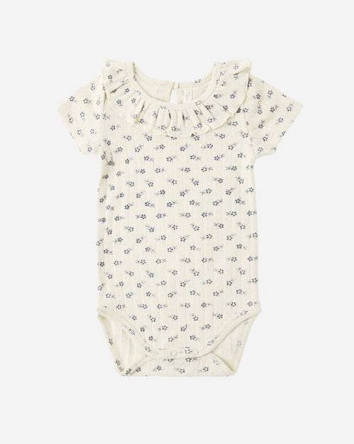 Baby romper with a subtle pattern on a white background