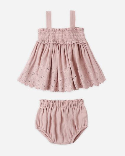 Pink baby dress with matching bloomers on a white background