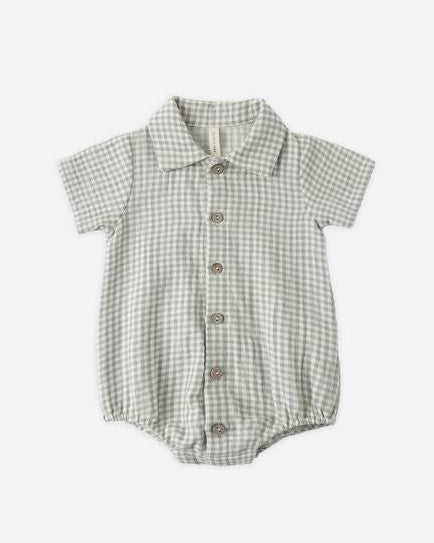 Green and white checkered baby romper on a light gray background