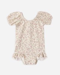 Floral-patterned baby romper on a white background