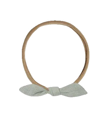 Two hairbands with bows, one beige and one brown, on a white background.