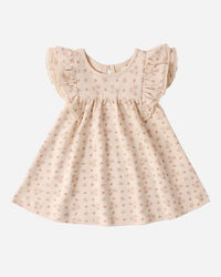 Beige baby dress with ruffled sleeves on a white background
