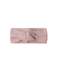 Pink headband with a knot on a white background