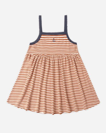 Striped dress with thin straps on a light gray background