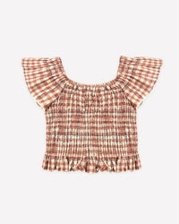 Plaid top with ruffled sleeves and hem on a white background