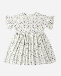 White dress with small black floral pattern on a white background