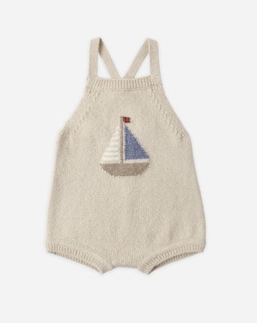 Knitted baby romper with sailboat design on a white background