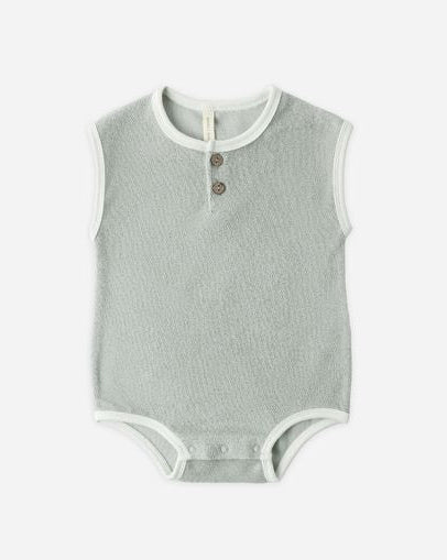 Gray baby bodysuit with white trim on a white background