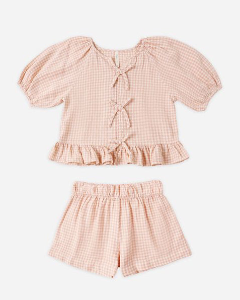 Pink checkered top and shorts set on a white background