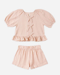 Pink checkered top and shorts set on a white background