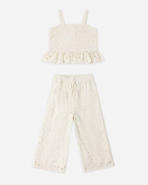 White lace top and pants set on a white background